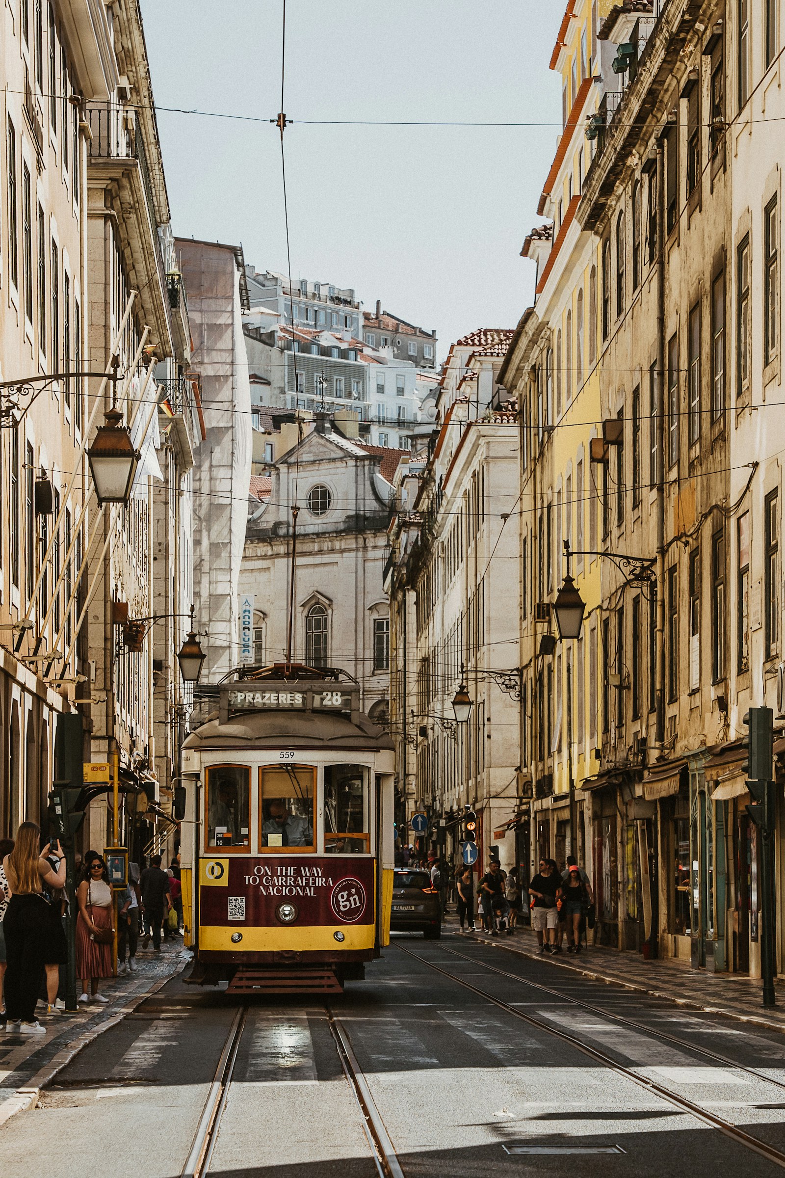 Yellow tram on a historic Lisbon street
